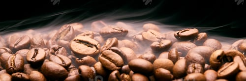 Preview: Close Up Studio Shot Of Smoking Roasted Coffee Beans Against Black Background