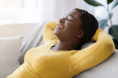 Preview: Domestic Relax. Smiling Black Lady Leaning Back On Couch With Closed Eyes