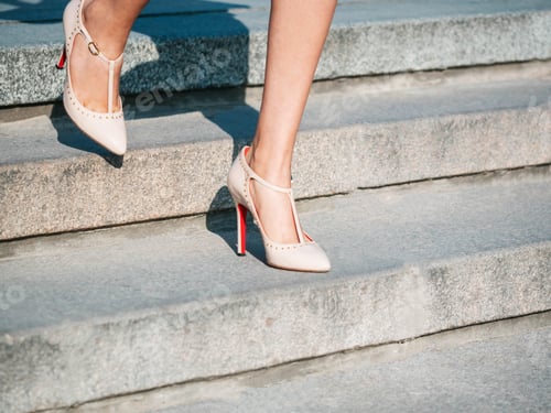 Preview: Sexy legs with high beige heels goes down the stairs of big city