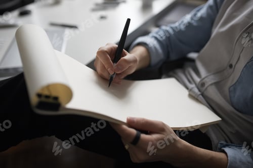 Preview: Designer hands drawing design project.