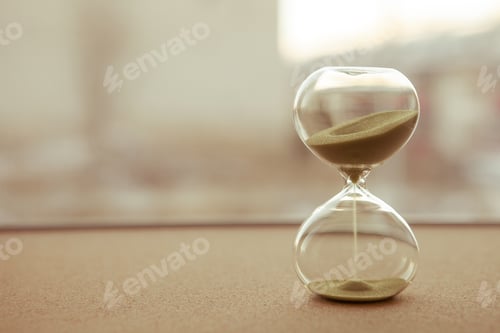 Preview: Sand running through the bulbs of an hourglass measuring the passing time