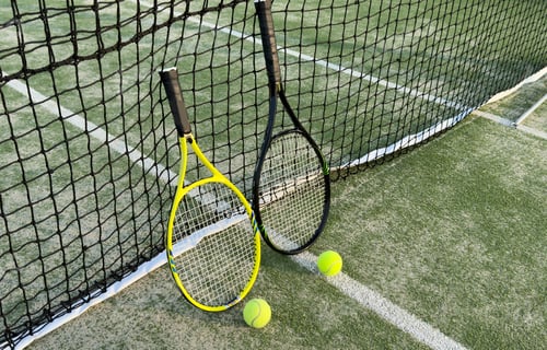 Preview: Tennis racket and tennis ball on court.