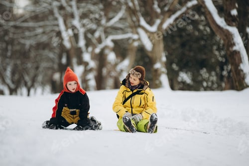 Preview: Mother and son enjoying winter park with snow