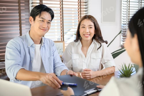 Preview: Couple meeting with female real estate agent consultant offering promotions