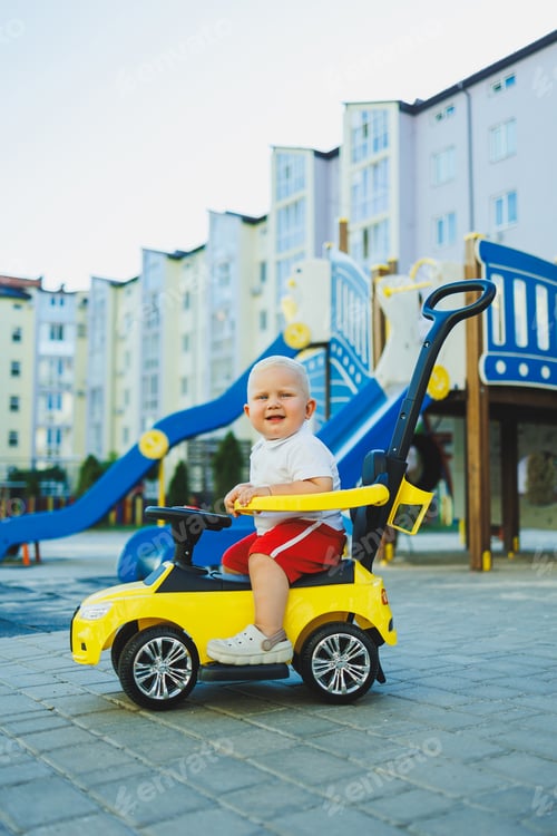 Preview: A little boy rides a tolocar. Tolokar for babies. Children's car for skating.