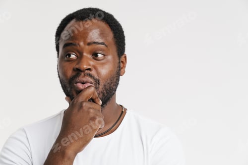 Preview: Black bristle man expressing surprise while holding his chin