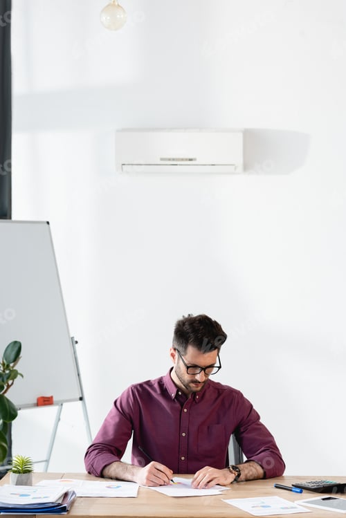 Preview: Man Working at Desk in Bright Modern Office