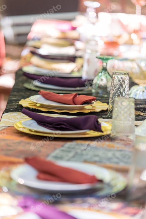 Preview: Vertical closeup shot of the reception table set for the wedding celebration