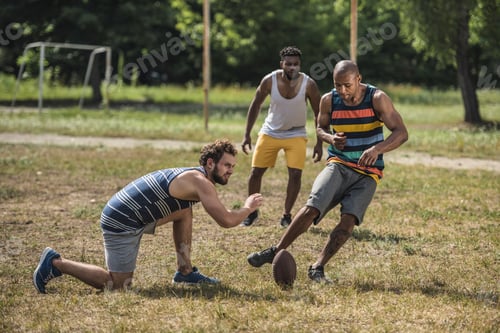 Preview: group of young multicultural men playing football on court