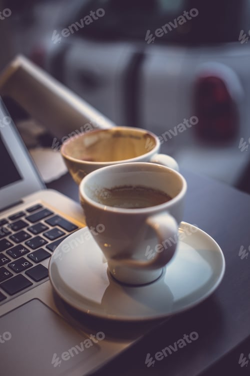 Preview: A laptop's keyboard and a cup of coffee.