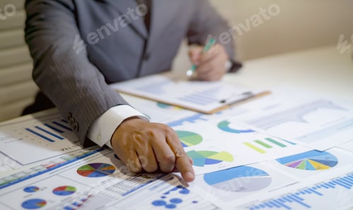 Preview: Business Man Analyzing Charts in an Office