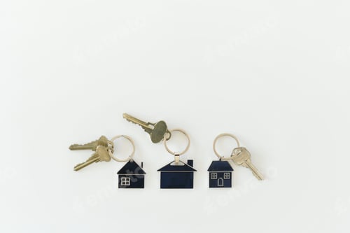 Preview: Housing Market & Real Estate concept - keys on key rings shaped like houses or homes in neighborhood