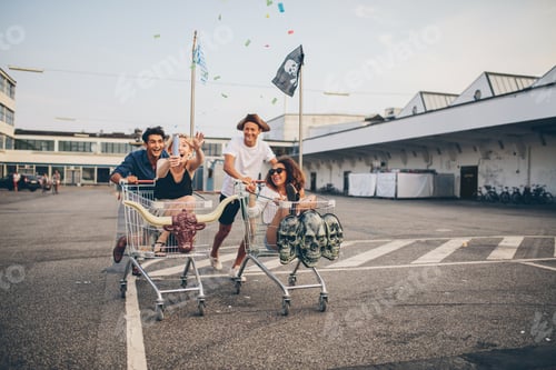 Preview: Young friends having fun on a shopping trolleys