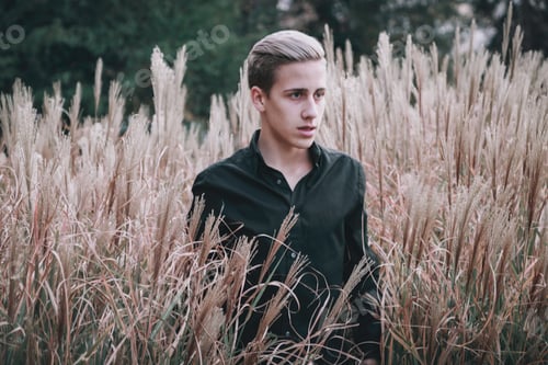 Preview: Handsome blonde man posing in the nature