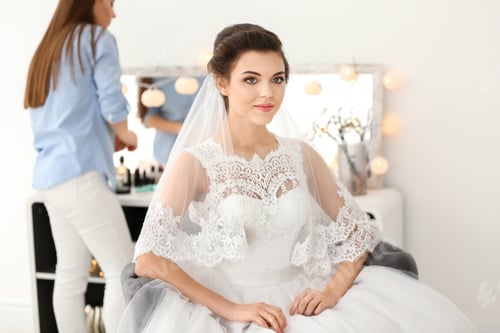 Preview: Beautiful young bride with makeup created by professional artist indoors