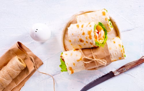 Preview: Burrito rolls with ham and cheese on a light background