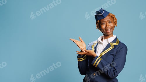 Preview: Young stewardess applauding in studio