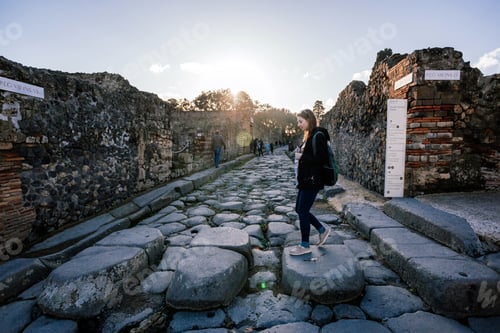Preview: A young girl's walking on the street of ancient Pompeii city.