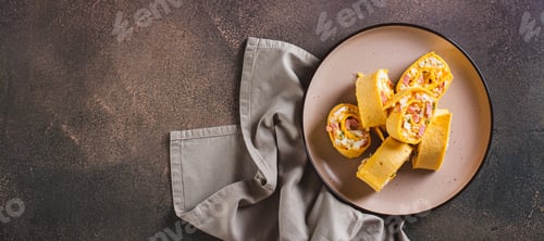 Preview: Tortilla rolls with salad of sausages, eggs, cheese and herbs on a plate top view web banner