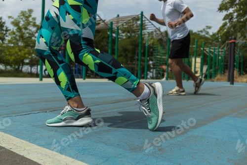 Preview: Girl's legs in sports shoes and leggings, close-up