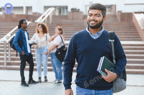 Preview: Indian student with books on university campus