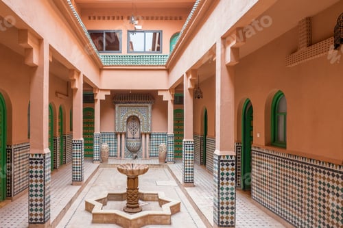 Preview: Wide angle shot of a fountain in a building surrounded with coral walls and columns