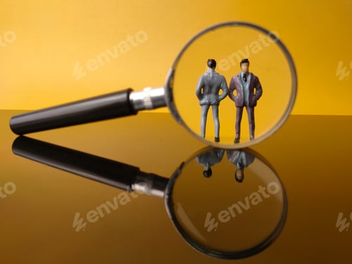 Preview: Miniature people and magnifying glass with reflection on a yellow background