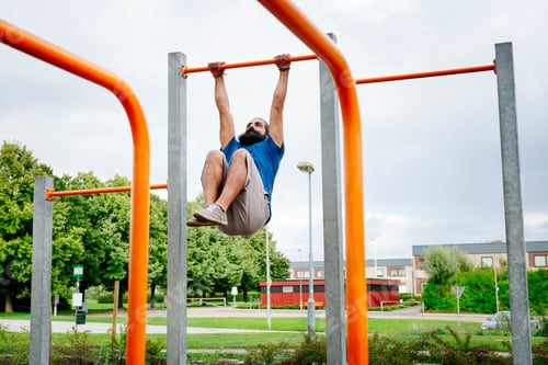 Preview: Man exercising on monkey bars