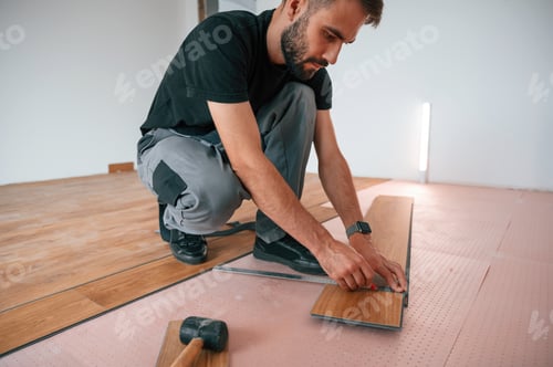Preview: Hand work. Man is installing new laminated wooden floor