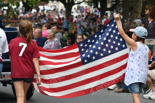 Preview: Girls carrying an American flag in parade