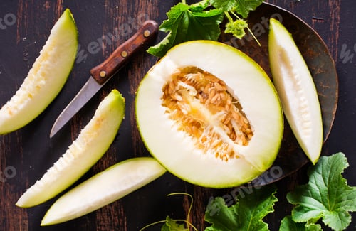 Preview: Wooden board with ripe cut melons