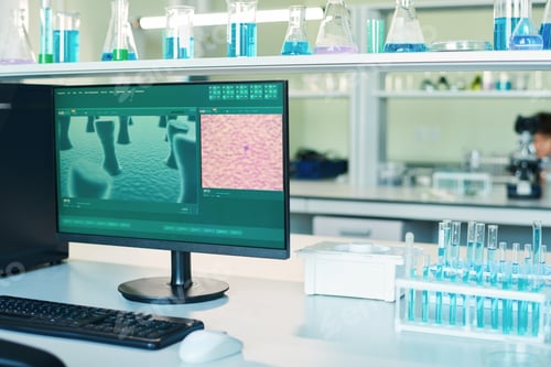 Preview: Workplace of modern clinician with computer screen and group of test tubes