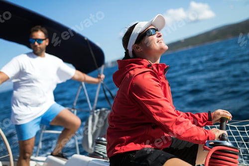 Preview: Attractive strong woman sailing with her boat