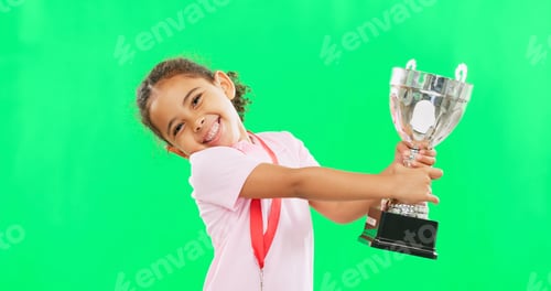 Preview: Happy, winning and face of child with a trophy isolated on a green screen studio background. Excite