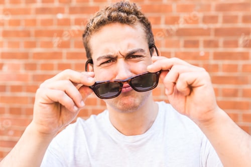 Preview: Funny man with sunglasses portrait wall on background