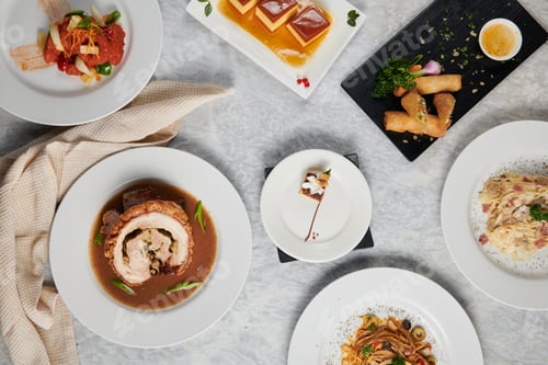 Preview: Top view of different decorated dishes served on plates on the table