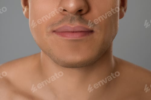 Preview: Man after shaving on grey background, closeup