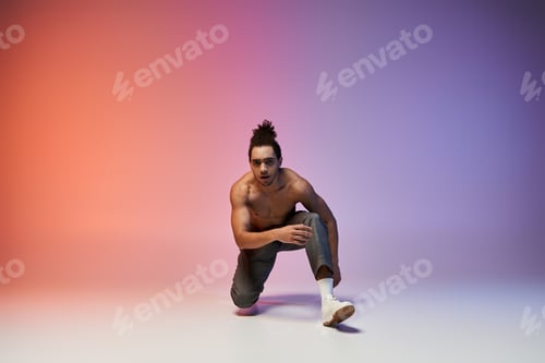 Preview: Young dancer poses in studio against gradient background
