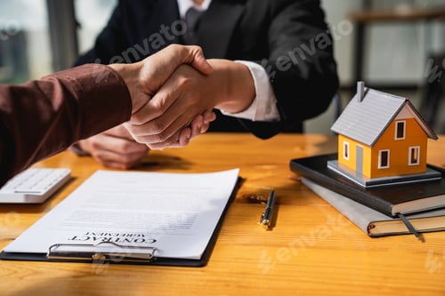 Preview: Successful deal Real estate lease or home purchase concept buyer shakes hands with bank employee aft