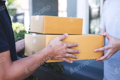 Preview: Delivery mail man giving parcel box to recipient