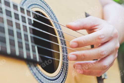 Preview: Close up image of Man playing an acoustic guitar