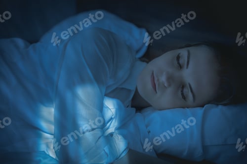 Preview: Pretty woman in bed peacefully sleeping at night