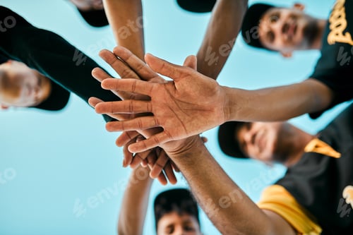 Preview: Shot of a team of young baseball players joining their hands together in a huddle during a game