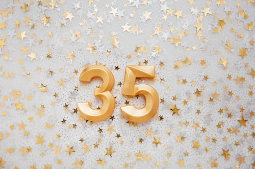 Preview: Number 35 thirty five golden celebration birthday candle on Festive Background.