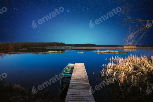 Preview: Moored Old Shabby Wooden Fishing Rowboat At Wooden Pier On Calm Water Of Lake, River. Amazing