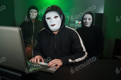 Preview: Team of Masked Hackers Using Computer to inflict Data Breach Attack on Government Servers