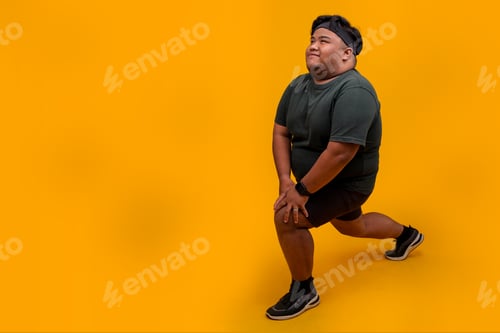 Preview: Full Size of Plus Size Man Doing Lunges While Looking Away Isolated on Yellow Background