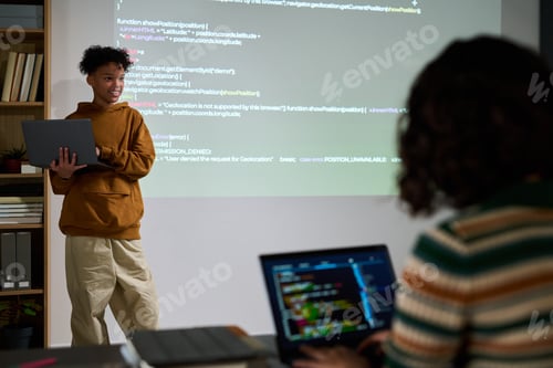 Preview: Teenage Boy Presenting Programming Code to Classmate