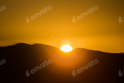 Preview: Majestic vivid sunset/sunrise over dark mountains silhouettes