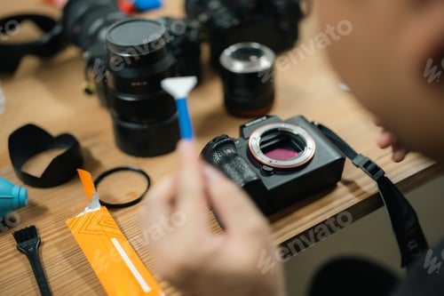Preview: Precision at Work: Camera Technician Expertly Cleans Sensor for Photography Equipment Performance